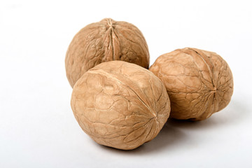 Walnuts close-up on a white background, natural vegetarian food. Selective focus