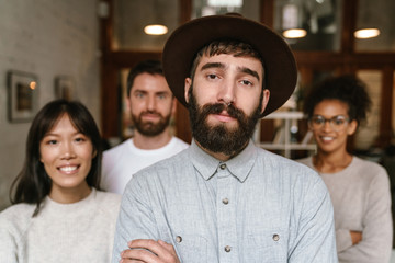 Image of multiethnic young business workers standing together at office