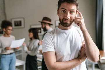 Image of multiethnic young business people working together at office