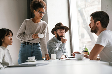 Image of multiethnic young business people working together at office