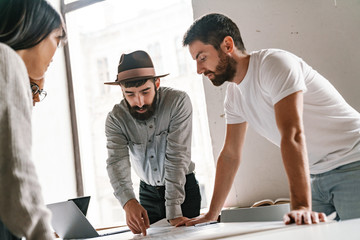 Image of multiethnic young business people working together at office