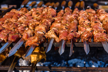 Skewers with meat over the charcoals. Cooking shashlik