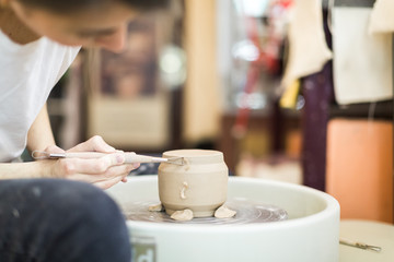 potter girl in the workshop with pottery
