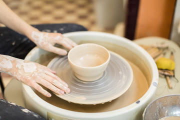 Fototapeta na wymiar potter girl in the workshop with pottery
