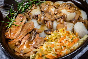 Stewed pork chop in a bright mushroom sauce.