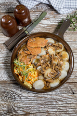 Stewed pork chop in a bright mushroom sauce.