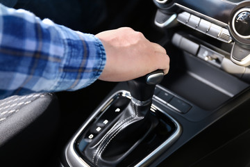 male hand engages automatic gear selector