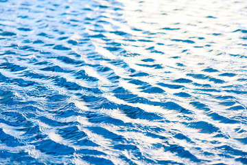 Water waves surface background. Aqua background texture. Abstract water ripples selective focus. Design element for banner and artwork