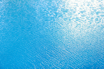 Fototapeta na wymiar Water waves surface background. Aqua background texture. Abstract water ripples selective focus. Design element for banner and artwork