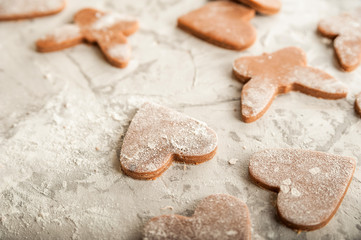 The process of making gingerbread. Flat lay flour heart dough. Texture of the dough for cookies close-up. Gingerbread dough on February 14, flour, rolling pin and copy space.