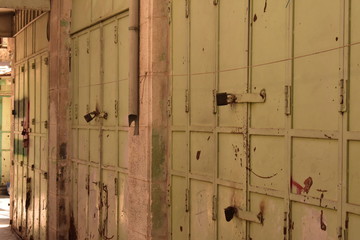 Green doors of an abandoned building in Hebron