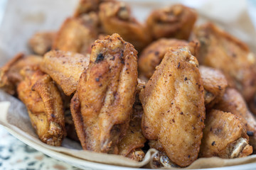 Close-up deep fried chicken wings with salt, Thai food.