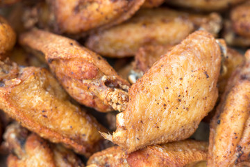 Close-up deep fried chicken wings with salt, Thai food.