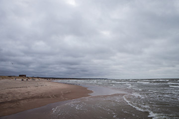 Seaside view of Baltic sea waves on a cloudy and stormy winter day near beach.