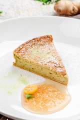 Sugar-free and gluten-free casserole with agave syrup on beautiful white plate on dark rustic tray on light concrete background in beautiful composition. Close-up. Space