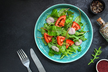 Healthy salad, leaves mix salad (mix micro greens, cucumber, tomato, onion, other ingredients). food background. copy space