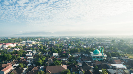 Residential neighborhood subdivision skyline Aerial shot. Top view of house Village from Drone capture. Top-down aerial drone image of a suburb in the midst of summer. Midtown of Indonesia.