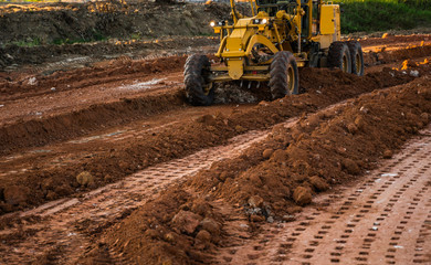 Grader is working on road construction. Grader industrial machine on construction of new roads....