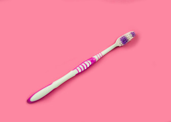 Toothbrush on a pink background.