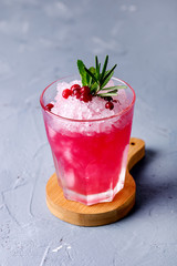Glass of Cold Cocktail with Cranberry Vodka Mint Blue background Summer Beverage