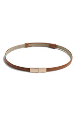 Subject shot of a thin belt made of brown patent leather and decorated with a golden buckle made as two right angled parts. The stylish belt is isolated on the white background.