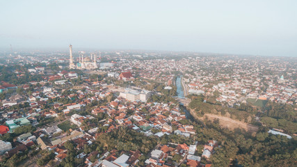 Residential neighborhood subdivision skyline Aerial shot. Top view of house Village from Drone capture. Top-down aerial drone image of a suburb in the midst of summer. Midtown of Indonesia.