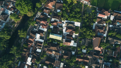 Residential neighborhood subdivision skyline Aerial shot. Top view of house Village from Drone capture. Top-down aerial drone image of a suburb in the midst of summer. Midtown of Indonesia.