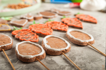 The process of painting gingerbread with glaze. Flat lay cookie eggs. Handpainted gingerbread bunnies and eggs for Easter and copy space.