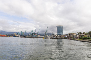 Fototapeta premium Cargo port on a rainy day on the Black Sea embankment of Batumi city - the capital of Adjara in Georgia