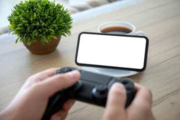 male hands holding joystick background of phone with isolated screen