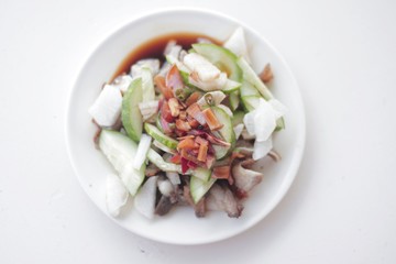 Delicious FIlipino Delicacy called Pork Kilawin or Kinilaw na Baboy on White plate