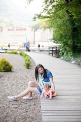 Fototapeta premium happy young mother and her daughter outdoor