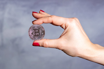 Woman hand holding  bitcoin cryptocurrency. Finance concept