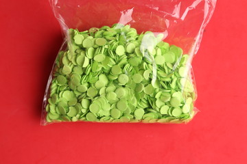 green party confetti in colorful background