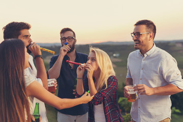 Friends blowingparty whistles