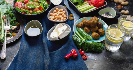 Vegetarian variety dishes on black background.