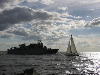 War and Peace. Warship and yacht. Gulf of Riga