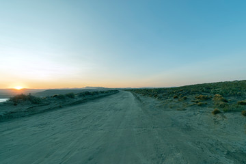 Fototapeta na wymiar Sunset over gravel road in the Patagonian steppe