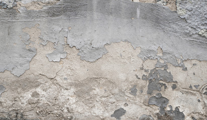 Cracked concrete grey wall covered with gray cement texture as background can be used in design. Dirty concrete texture with cracks and holes.