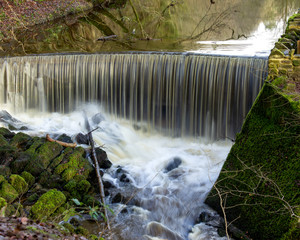 The roaring waters pouring over the edge of the Round Dam is one of the first features to greet walkers in Castle Woods in Skipton