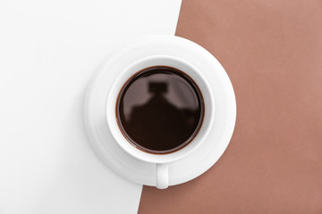 Obraz na płótnie Canvas Cup of hot coffee on color background