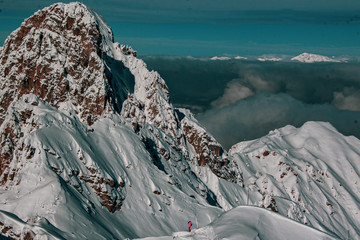 The Freerider paused before descending at the edge of a gorge with a powerful ridge and fog in the...