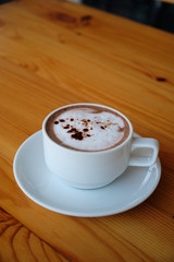 cup of coffee on wood table closeup