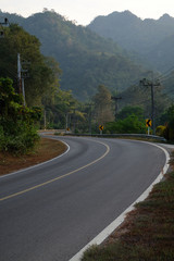 Fototapeta na wymiar Curve way of asphalt road near mountain range