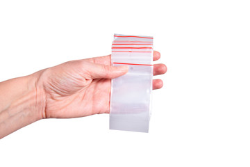 Lot of zipper storage bags, slider storage bags ob grey background in woman habd
