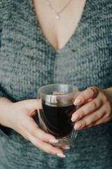 girl with a cup of hot coffee in her hands