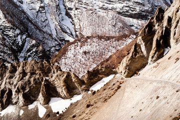 Group of travelers walks on footpath in Himalayas.