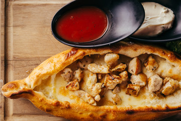 close up calzone pizza on wooden board