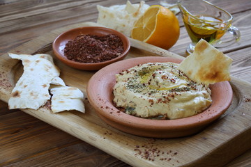 Hummus and pita on a wooden table