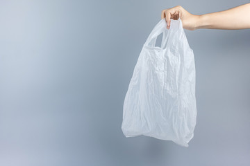 Man holding plastic bag against gray background with Copy space for text. Environmental Protection, Zero waste, Reusable, Say No Plastic, World Environment day and Earth day concept